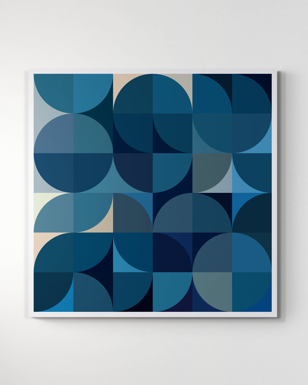 A giclée print of a colorful geometric digtal artwork on a white wall. Abstract floral pattern, mainly blue and white colors